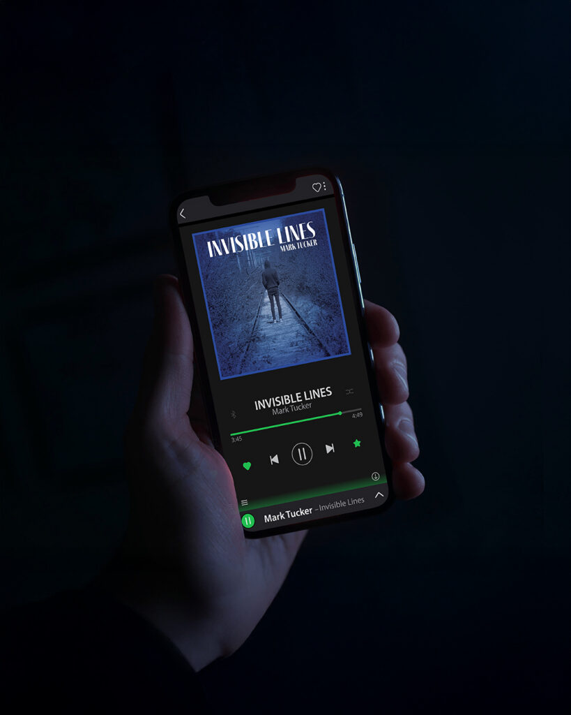Hand holding a phone showing Invisible Lines album playing on Spotify