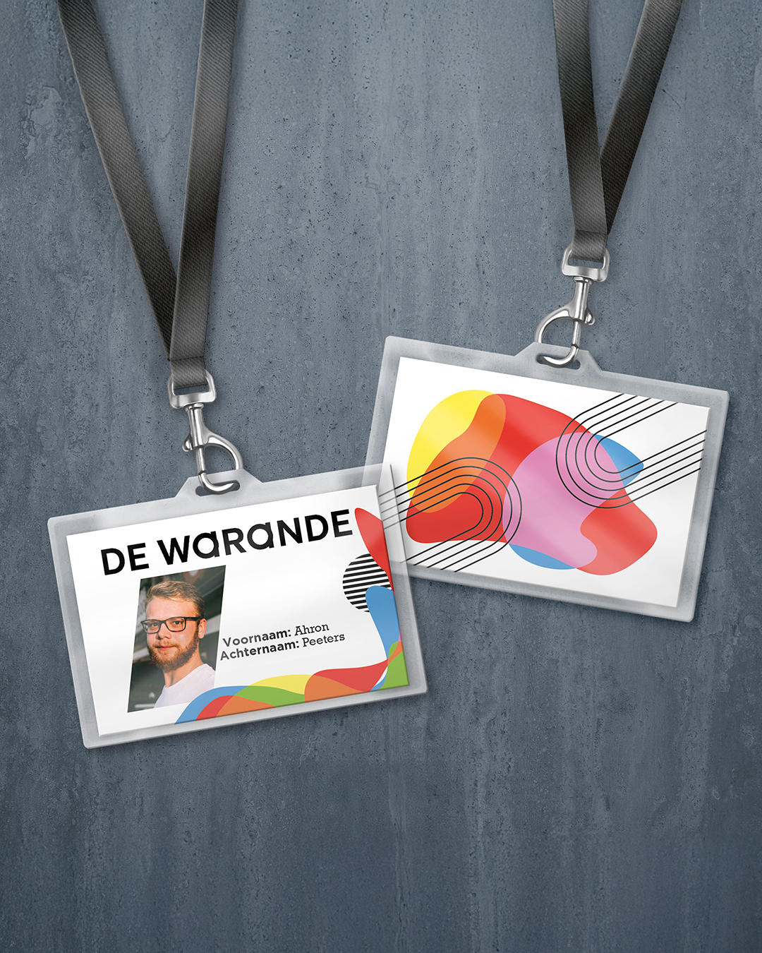 Front and back of De Warande 2022-2023 season attendee badge on a lanyard